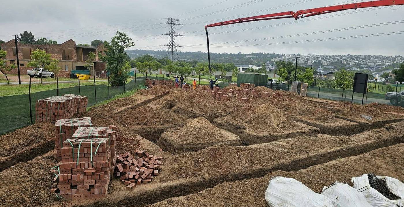 Foundation trenches excavated and brick stock delivered to a residential construction site