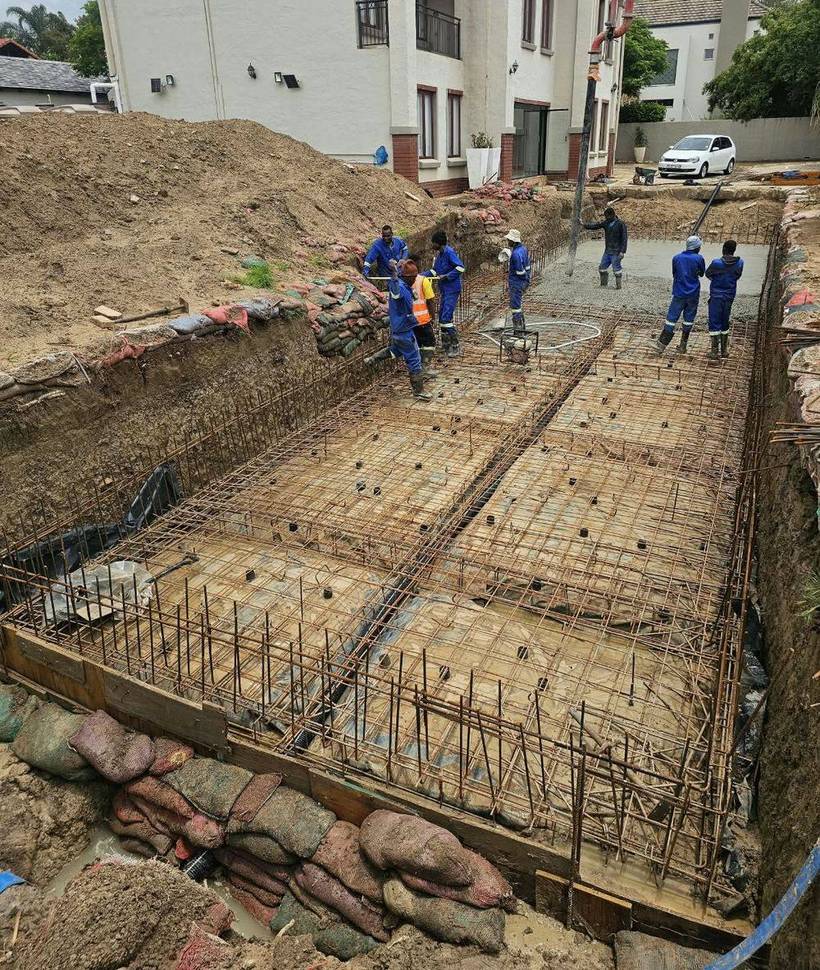 Reinforced raft foundation with rebar in place during a concrete pour
